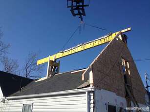 boomtruck Crane Lifting the House